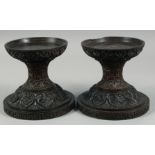 A PAIR OF 19TH CENTURY ANGLO INDIAN CARVED HARDWOOD PEDESTAL STANDS, 17.5cm high.