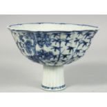 A CHINESE BLUE AND WHITE PORCELAIN STEM CUP, painted with plum blossom, bamboo and other flora,