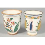 A PAIR OF TURKISH KUTAHYA POTTERY WATER CUPS, each painted with floral motifs, 8cm high.