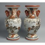 A PAIR OF JAPANESE KUTANI PORCELAIN TWIN HANDLE VASES, painted with figures in outdoor scenes and