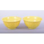 A PAIR OF CHINESE YELLOW GLAZED PORCELAIN CUPS, each with six-character mark to base, 7.5cm