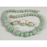 A 14CT GOLD AND JADE RING AND EARRINGS, together with a graduated jade bead necklace, (4 pieces).