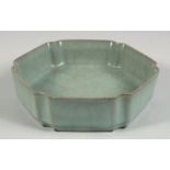 A CHINESE RU STYLE CELADON HEXAGONAL BRUSH WASHER, the base with incised calligraphy, 17.5cm at