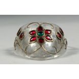 AN INDIAN MUGHAL ARCHER'S RING, onlaid with floral wire work and semi precious stones.