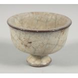 A CHINESE CRACKLE GLAZE FOOTED CUP, 8cm diameter.