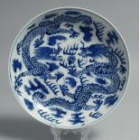A CHINESE BLUE AND WHITE PORCELAIN DISH, painted with dragons and the flaming pearl of wisdom, six-