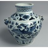 A CHINESE BLUE AND WHITE PORCELAIN TWIN HANDLE VASE, the body decorated with phoenix and flora, 27.