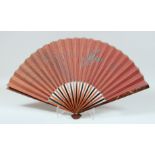 A JAPANESE LACQUERED WOOD FOLDING FAN, the lacquered guards decorated with carp and insects.