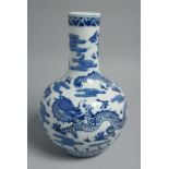 A CHINESE BLUE AND WHITE PORCELAIN BOTTLE VASE, painted with dragons and the flaming pearl of