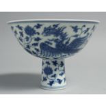 A CHINESE BLUE AND WHITE PORCELAIN STEM CUP, the exterior painted with exotic birds, flora and vine,