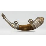 A 19TH CENTURY MOROCCAN SILVER AND BRASS MOUNTED POWDER HORN, the horn overlaid with velvet, 35cm