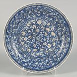 AN 18TH/19TH CENTURY OTTOMAN IZNIK GLAZED POTTERY PLATE, decorated in blue and white with