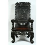 A LARGE CHINESE CARVED ROSEWOOD THRONE / ARMCHAIR, the cresting rail with carved and pierced