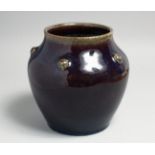A CHINESE FLAMBE GLAZE PORCELAIN JAR, the shoulder with five raised bosses, the base with six-