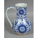 A TURKISH KUTAHYA BLUE AND WHITE GLAZED WATER JUG, painted with stylised flower heads, (AF), 22cm