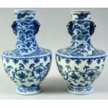 AN UNUSUAL PAIR OF CHINESE BLUE AND WHITE PORCELAIN VASES, the neck and shoulders decorated with