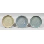 A GROUP OF THREE CHINESE GLAZED POTTERY DISHES, two with blue glaze and raised decoration