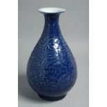 A CHINESE BLUE GLAZE PORCELAIN VASE, the body with carved floral decoration, base with six-character