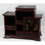 A 19TH CENTURY CHINESE LACQUERED WOOD CABINET, comprising two doors and three drawers, 50cm high,