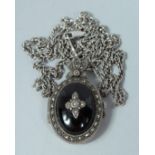 A SILVER MARCASITE LOCKET AND CHAIN
