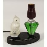AN ART DECO LAMP, parrot and scent bottle on an oval base.