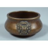 A CHINESE BRONZE CIRCULAR CENSER with lion handles. 4ins diameter.
