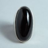 A BLACK ONYX AND SILVER RING