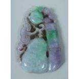 A LARGE CARVED TWO TONE JADE PENDANT 10cm long.