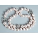 A CHANEL LARGE 43 PEARL NECKLACE with brilliant set double C clasp.