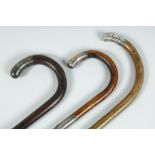 THREE VICTORIAN WALKING STICKS with silver tip handles.