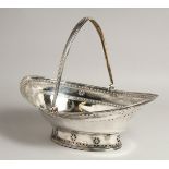 A LARGE GEORGE III SILVER OVAL CAKE BASKET with swing handles engraved with garlands. 13ins long.