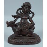 A CHINESE BRONZE BUDDHA riding on an oxen. 8.5ins high.