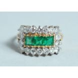 A GOOD DIAMOND AND EMERALD RING.