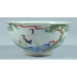 A CHINESE BOWL decorated with storks and flowers. 6ins diameter.