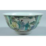 A CHINESE BOWL decorated with panels of figures. 6ins diameter.