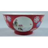 A CHINESE BOWL decorated with panels of figures and birds. 5.75ins diameter.