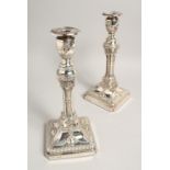 A GOOD PAIR OF GEORGIAN DESIGN SILVER CANDLESTICKS with swags, urns and garlands, with loaded bases.