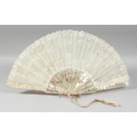 A GOOD VICTORIAN MOTHER OF PEARL AND LACE FAN. 20ins open in a box. Rougier, Paris.