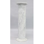 A VEINED MARBLE COLUMN with circular top. 3ft 3ins high, top 1ft square.