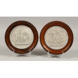 AFTER THE ANTIQUE. A PAIR OF CLASSICAL CIRCULAR PLAQUES, framed and glazed. 5ins diameter.