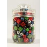 A COLLECTION OF DICE in a glass jar.