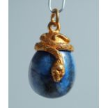 A RUSSIAN SILVER AND LAPIS EGG PENDANT with inter twined snake. 2.5cm long.
