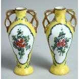 A MINIATURE PAIR OF YELLOW GROUND PORCELAIN TWO HANDLED VASES. 3.75ins high.