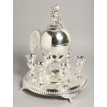 A GOOD CIRCULAR PLATED EGG CRUET with small egg cups and egg tureen.