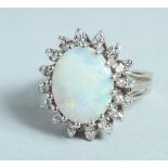 AN 18CT WHITE GOLD, OPAL AND DIAMOND CLUSTER RING.