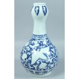 A CHINESE BLUE AND WHITE GARLIC HEAD VASE decorated with phoenix and clouds. 13ins high.