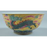A CHINESE BOWL decorated with animals on a yellow ground. 5.75ins diameter.