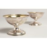 A PAIR OF GEORGE III SILVER CIRCULAR SALTS London 1972 3.75ins diameter.