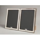 A PAIR OF SILVER BEAD EDGE PHOTOGRAPH FRAMES. 7.5ins x 5.5ins.