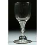 A LARGE GEORGIAN WINE GOBLET with white opaque stem, bowl 6.5cm deep, 16cm high.